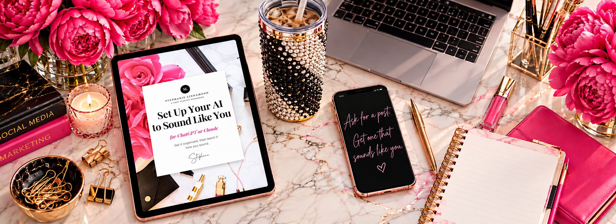 The Set Up Your AI to Sound Like You workbook on a tablet, on a pink marble desk with peonies